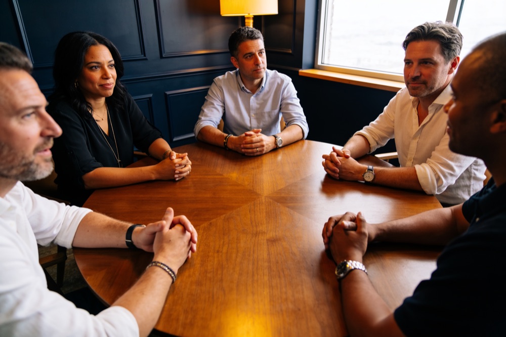 An intimate Connector Mastermind of members in discussion